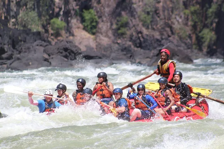 A raft running a rapid in the Batoka Gorge on white water rafting, one of the Zambezi River tours